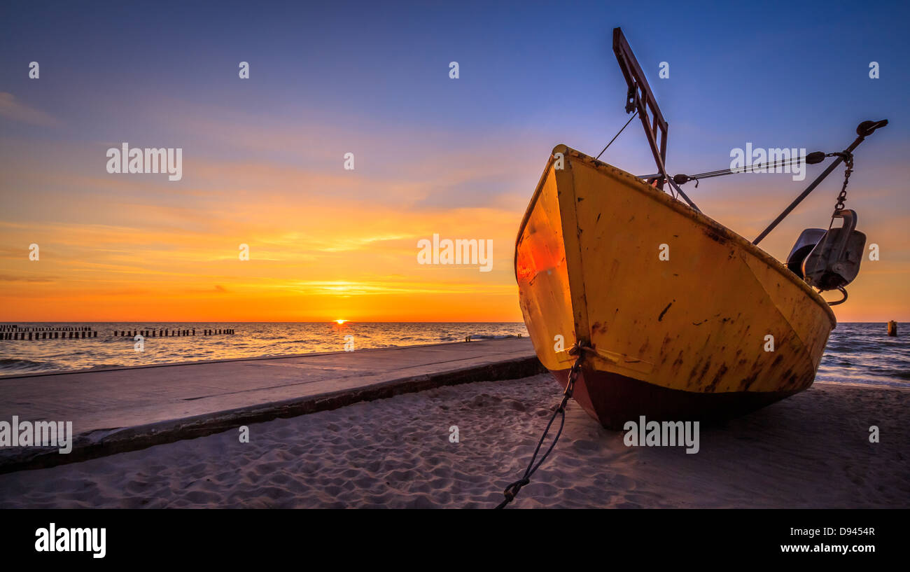 Fishing boat during sunset Stock Photo - Alamy