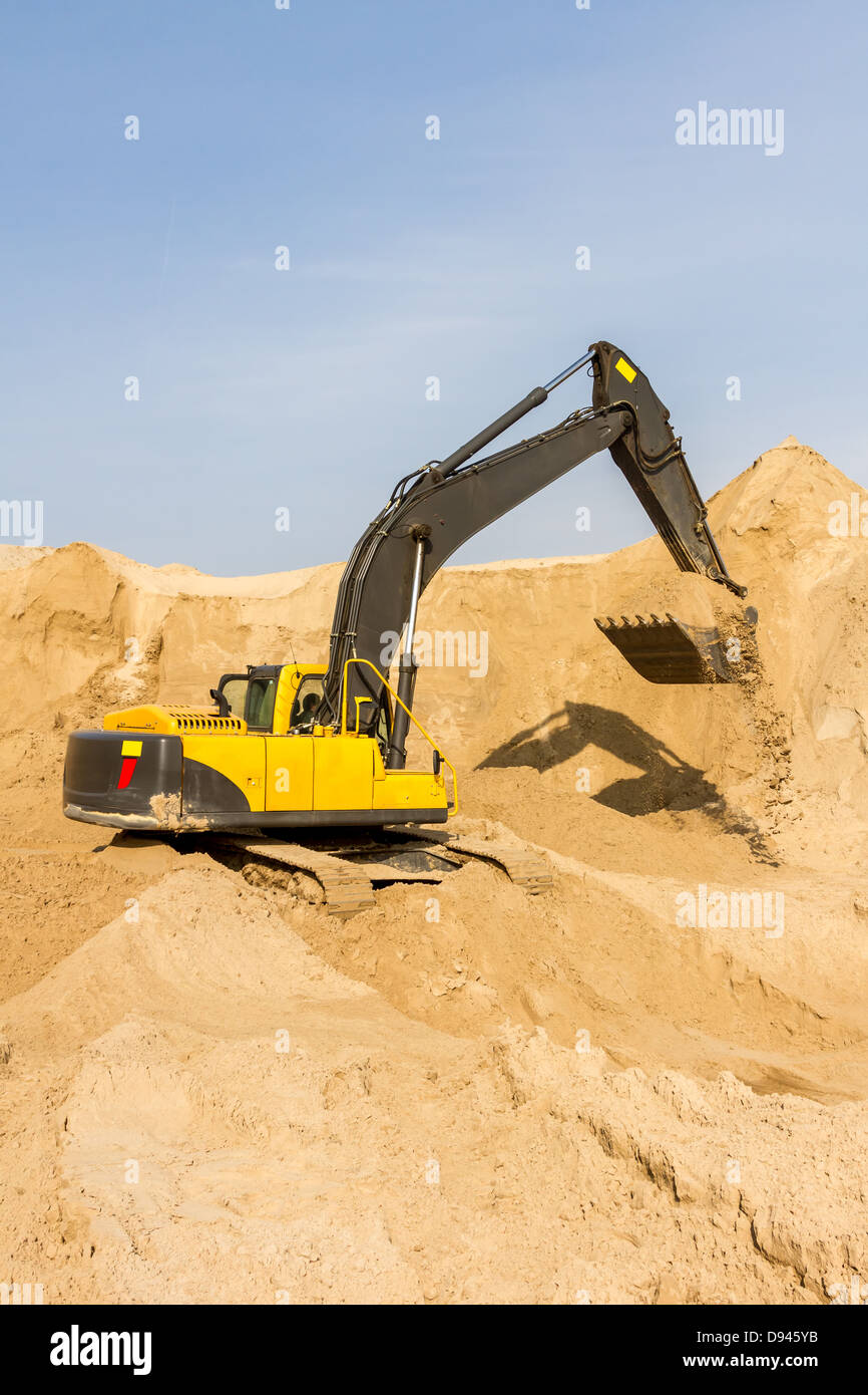 Working Yellow Excavator at Construction Site Stock Photo - Alamy