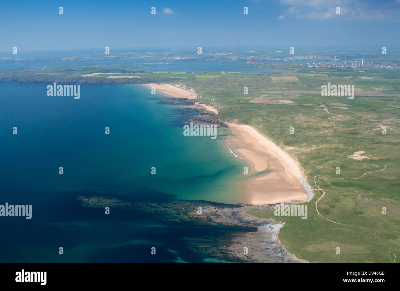 Aerial view of Freshwater West beach with Milford Haven and Rhoscrowther refinery in background Pembrokeshire West Wales UK Stock Photo