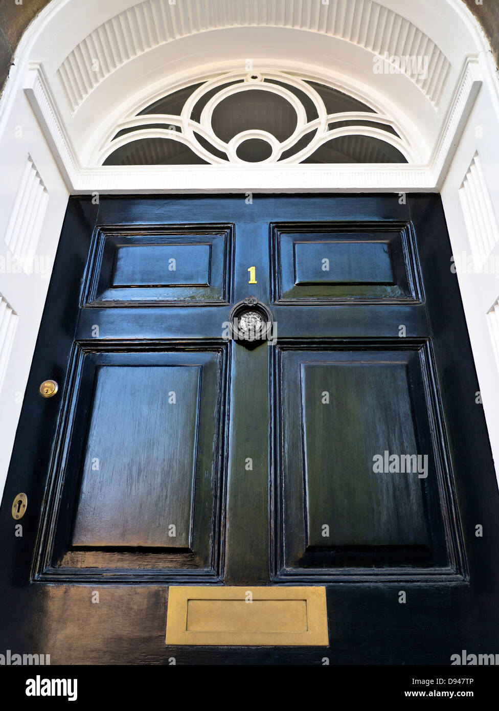 An imposing black paneled front door 'Number 1' with