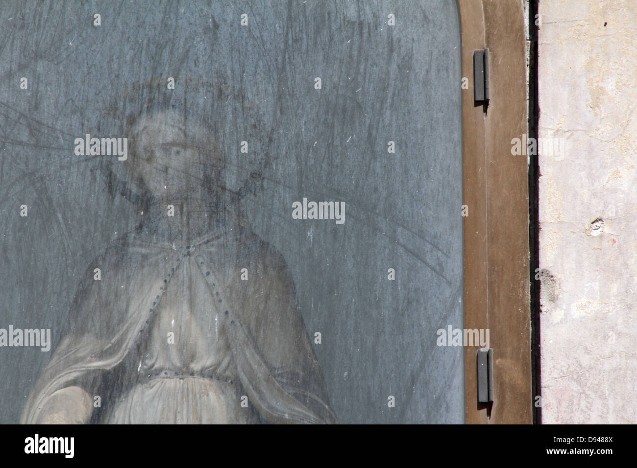 female religious statue in street side altar by church in rome italy