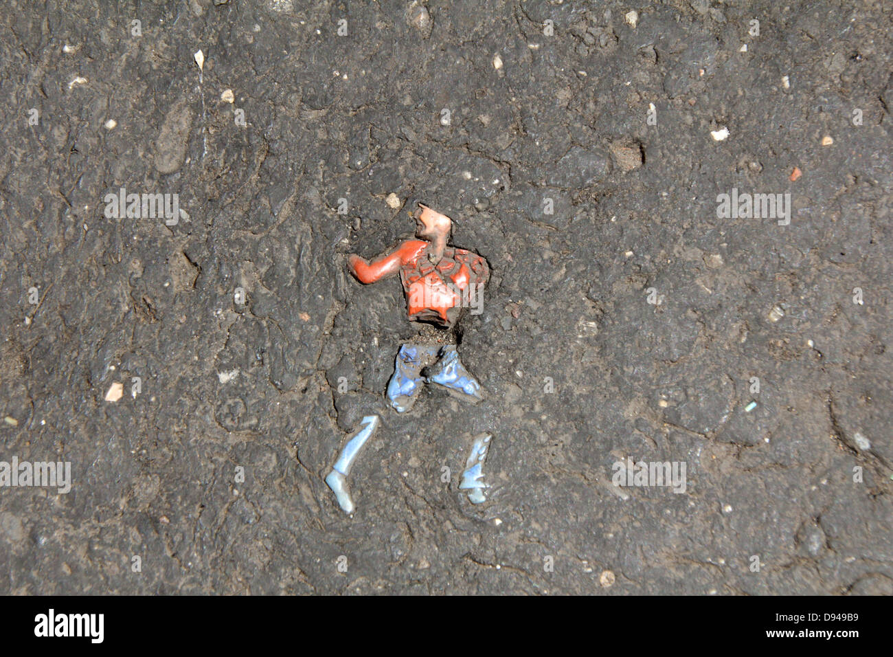 item embedded in hot tarmac road surface in sun Stock Photo