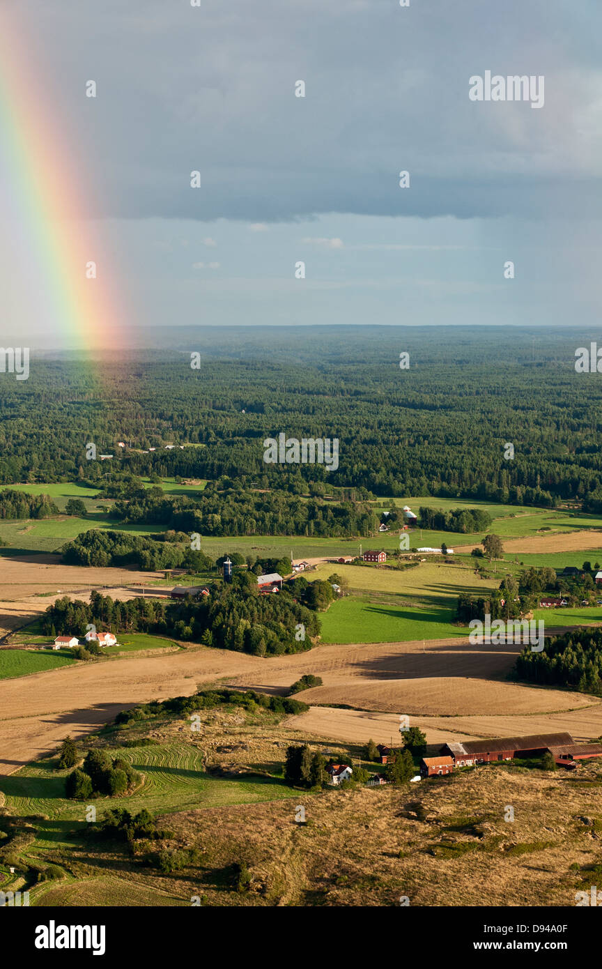 Rainbow above fields Stock Photo - Alamy