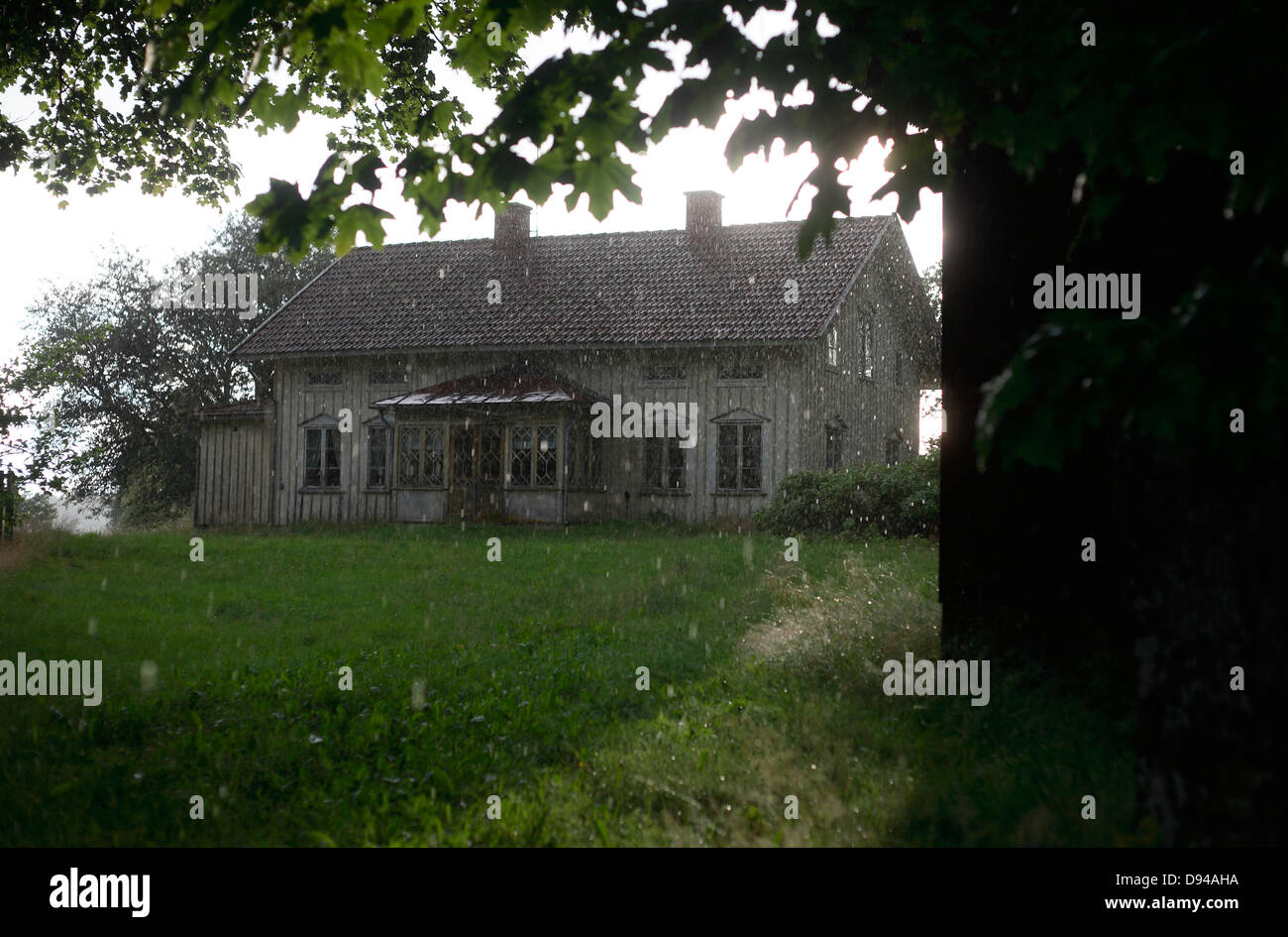 Farmhouse in rain Stock Photo - Alamy