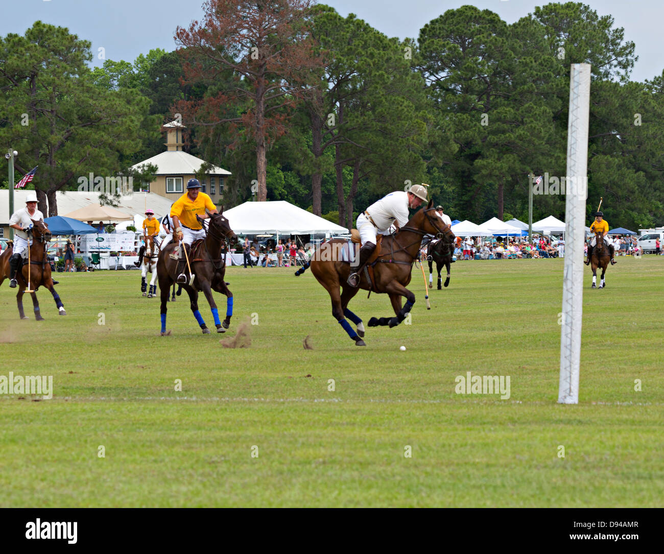 Polo match at Rose Hill Equestrian Center in Bluffton, South Carolina. Players race towards the ball as it nears the goal posts. Stock Photo