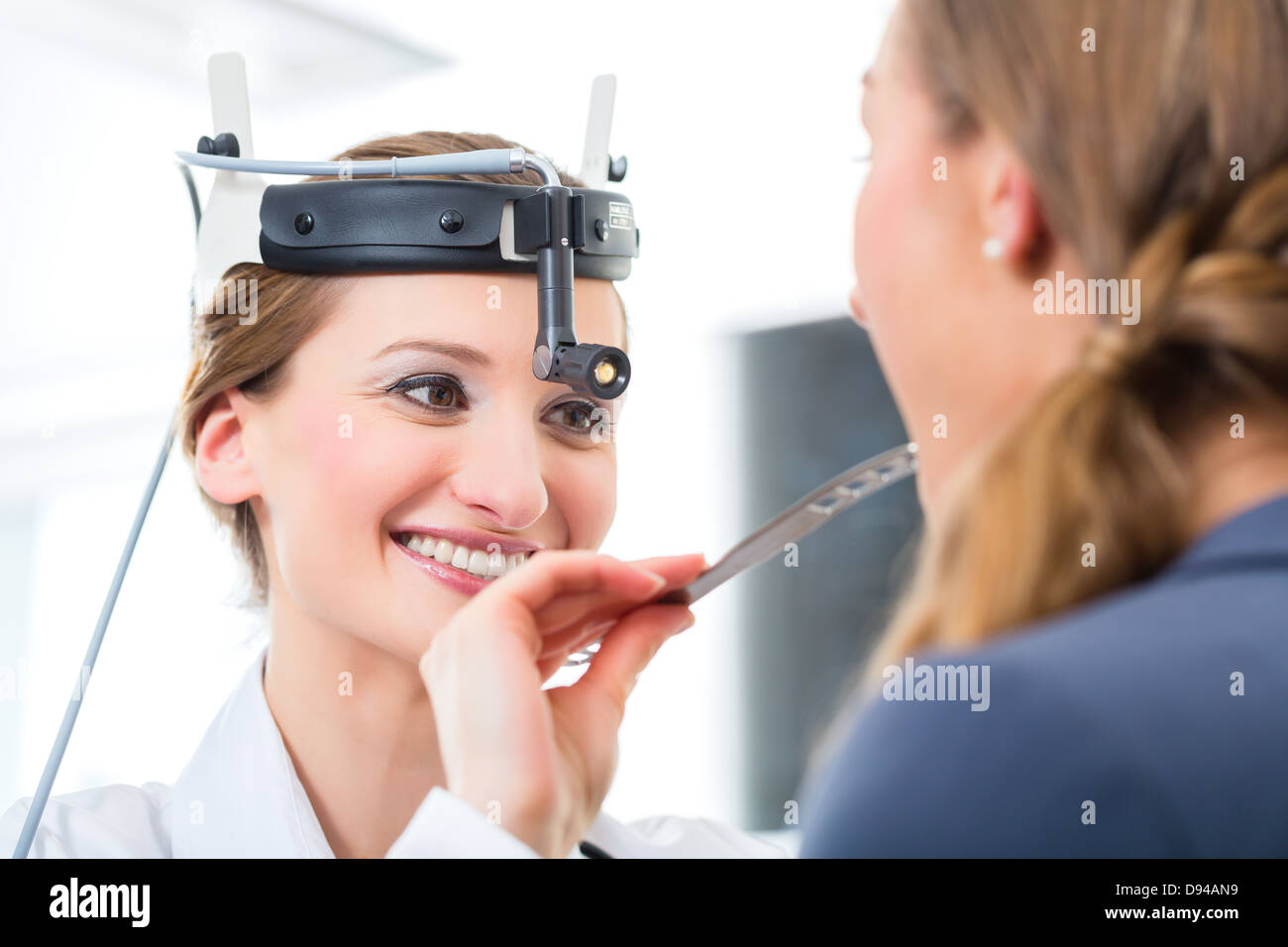 Doctor Young female doctor or ENT specialist with a patient in her