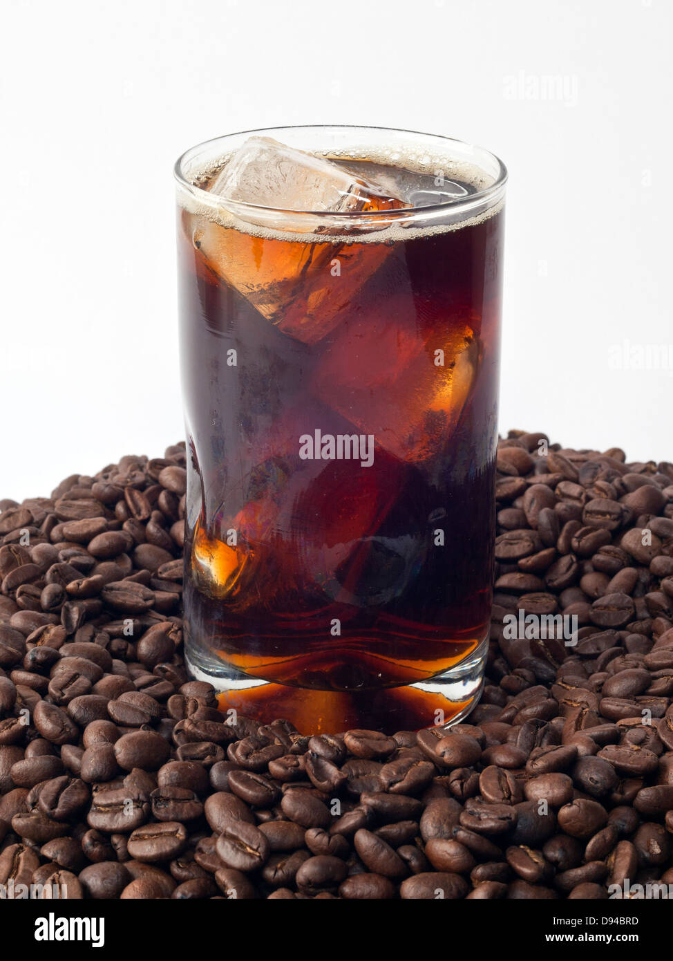 Iced coffee in glass on top of beans Stock Photo