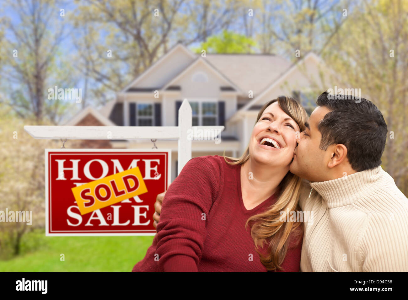 Happy Mixed Race Couple in Front of Sold Home For Sale Real Estate Sign ...