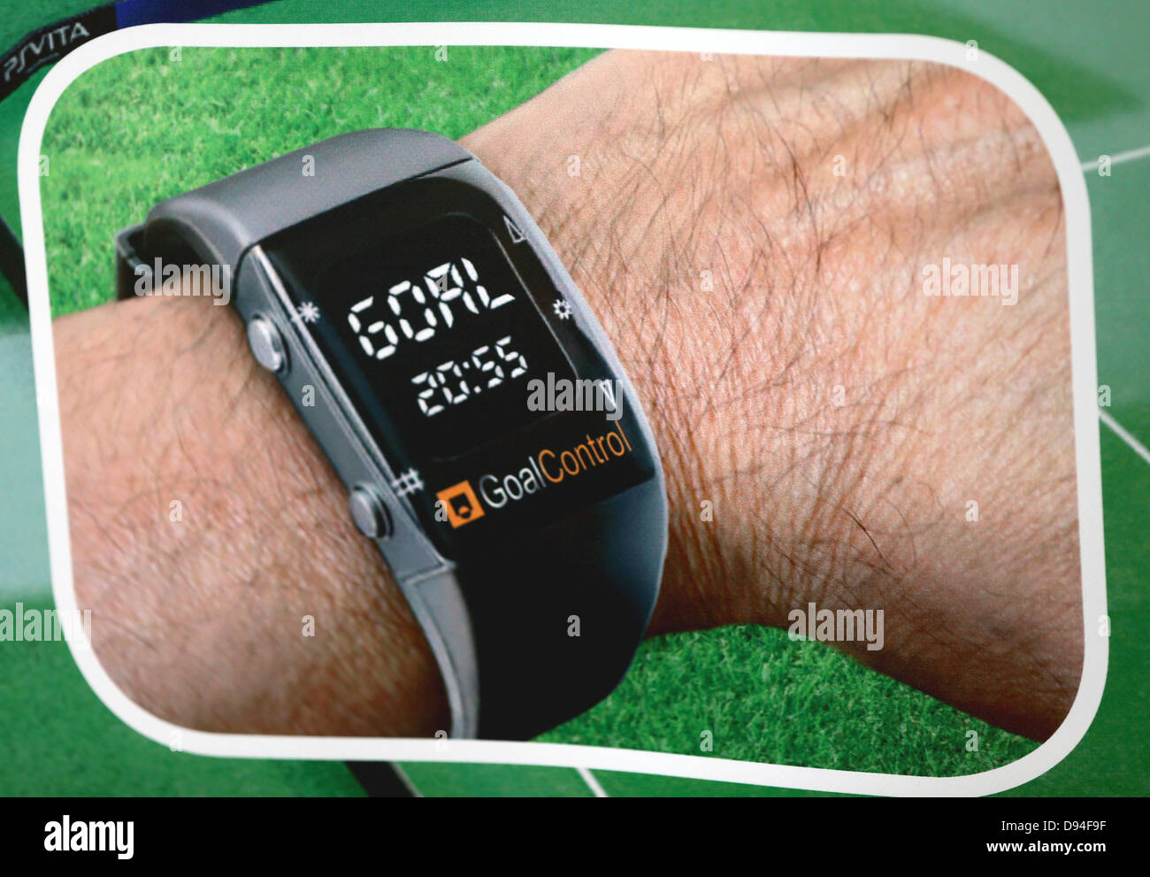 A photograph of a placard shows a wrist watch  for the referee displaying a goal score in Wuerselen, Germany, 23 May 2013. The wrist watch was developed by the company GoalConrol which is going to introduce its goal-line technology in the forthcoming Confederations Cup 2013 in Brazil from 15 June to 30 June. The system includes seven high-speed cameras which are attached to the ceiling of the stadium right above a goal on each side of the pitch. The cameras are connected via optical vibre cables with a control room which allows the exact pinpointing of an incoming ball passing the goal line an Stock Photo