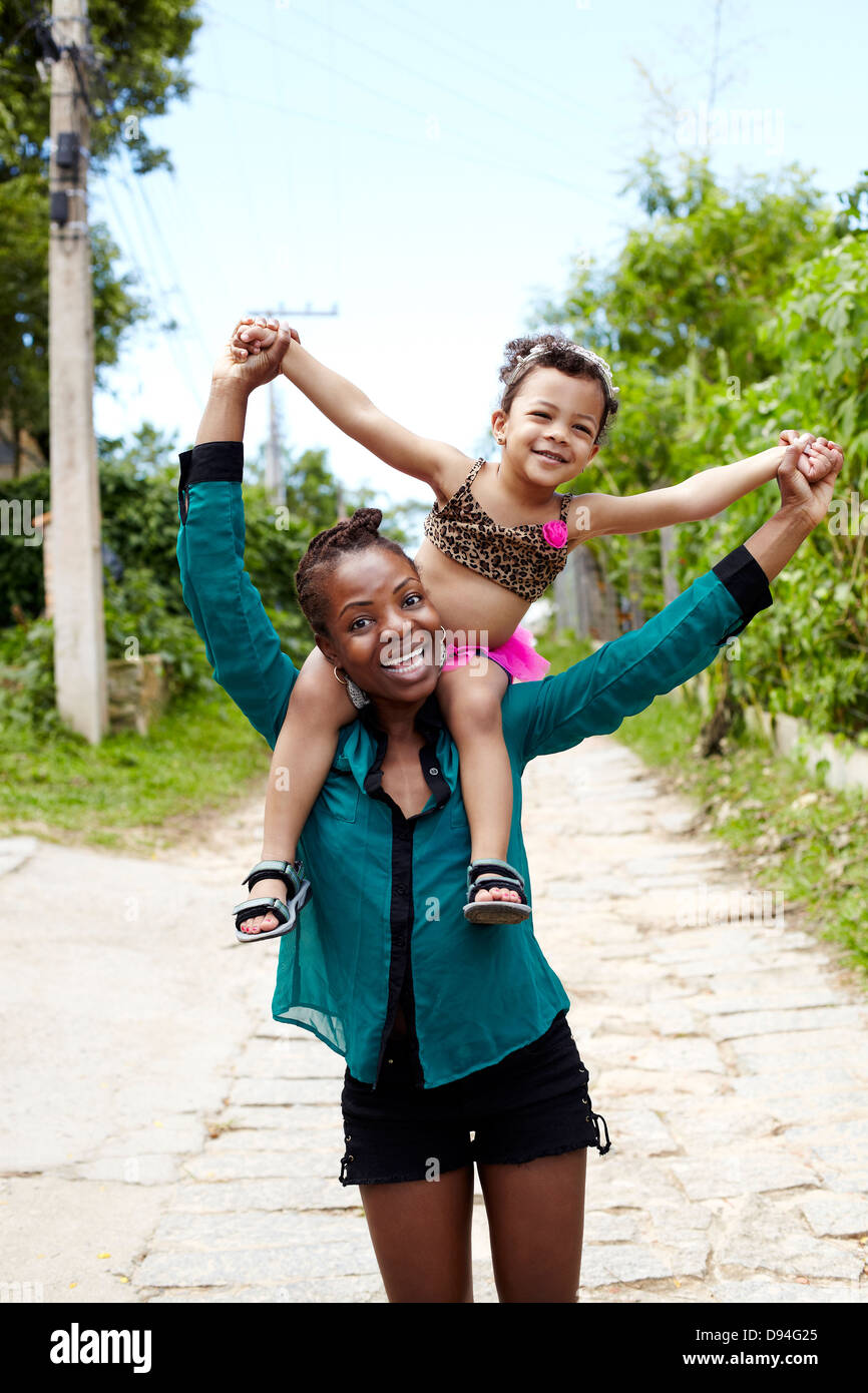 Mother carrying daughter on shoulders Stock Photo Alamy