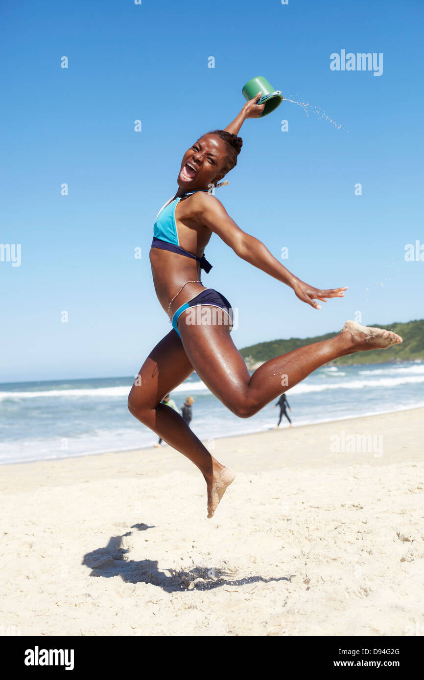 Woman jumping for joy bikini hi res stock photography and images