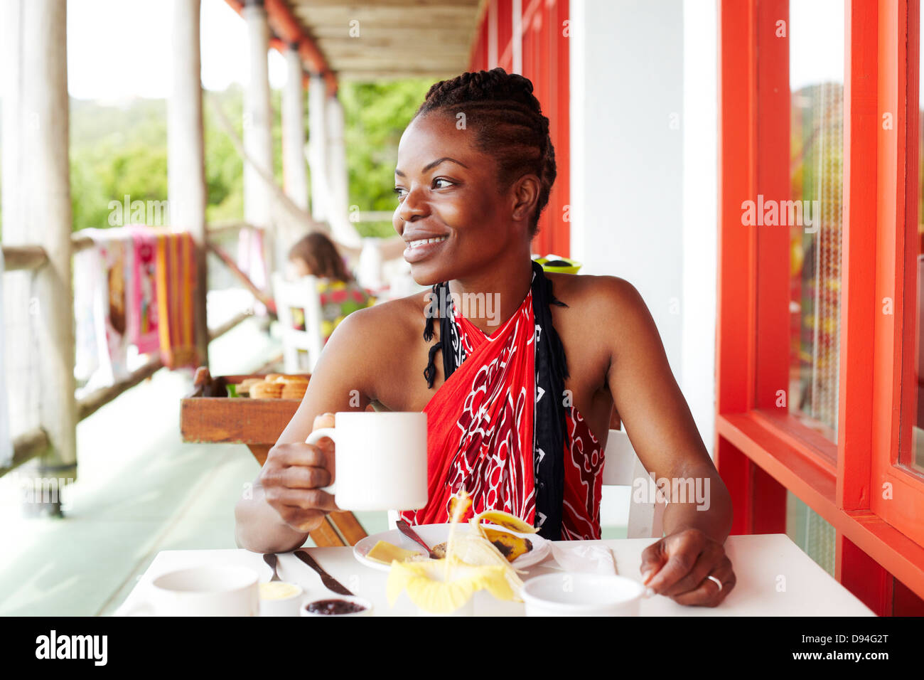 Black woman smiling at lunch Stock Photo