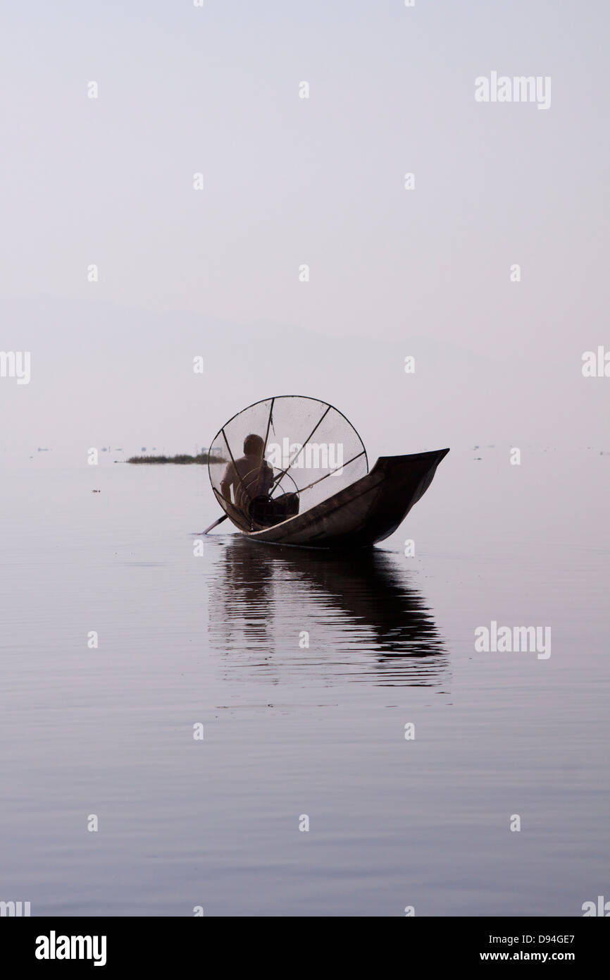 An traditional 'leg rower' fisherman on Inle Lake wearing the ...