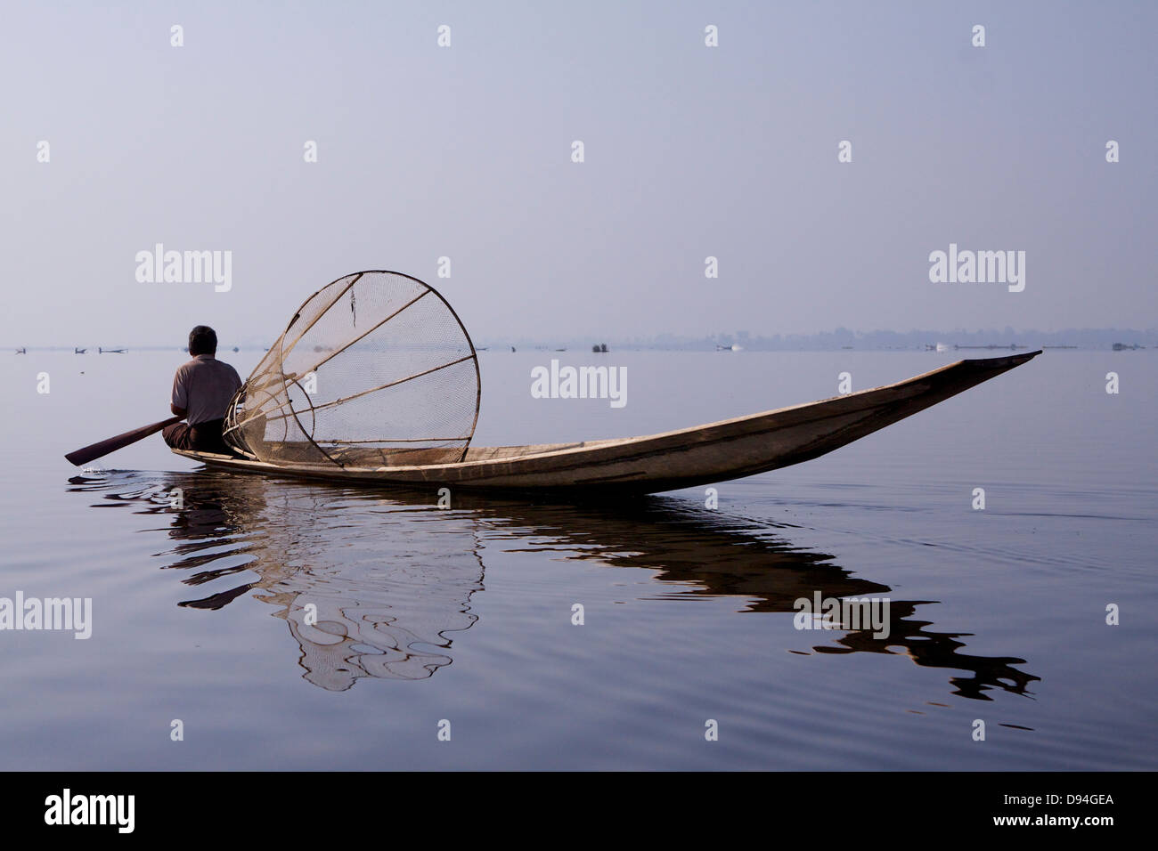 An traditional 'leg rower' fisherman on Inle Lake wearing the ...