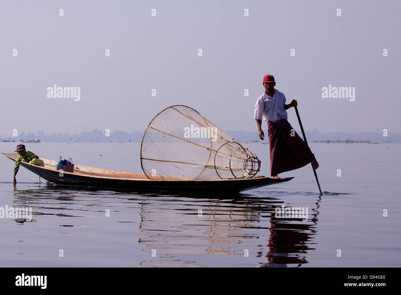 An traditional 'leg rower' fisherman on Inle Lake wearing the ...