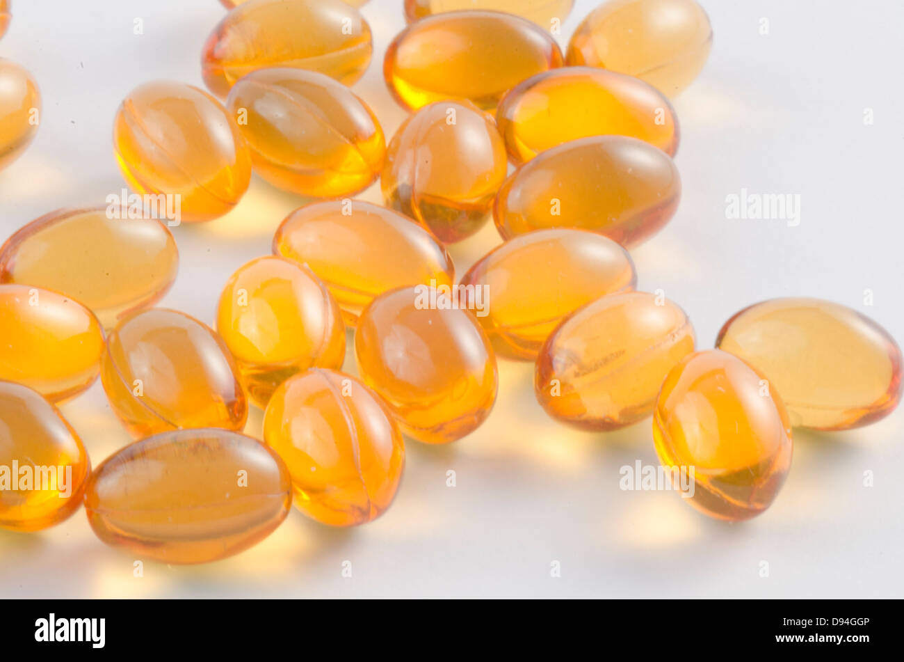 Medical capsules with golden colour and liquid Stock Photo