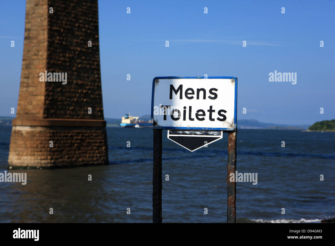Interesting sign for Mens toilets which appears to indicate it's the sea - there is, however,  a toilet block below. Stock Photo