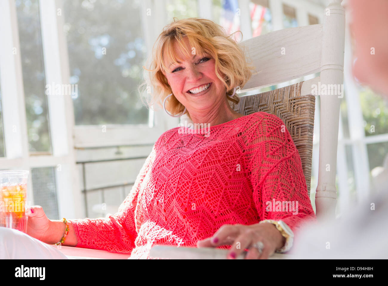Woman sitting on her porch hi-res stock photography and images - Alamy