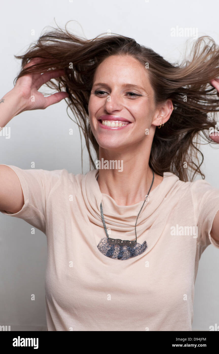 A laughing, hip and trendy young woman on white background Model release available Stock Photo