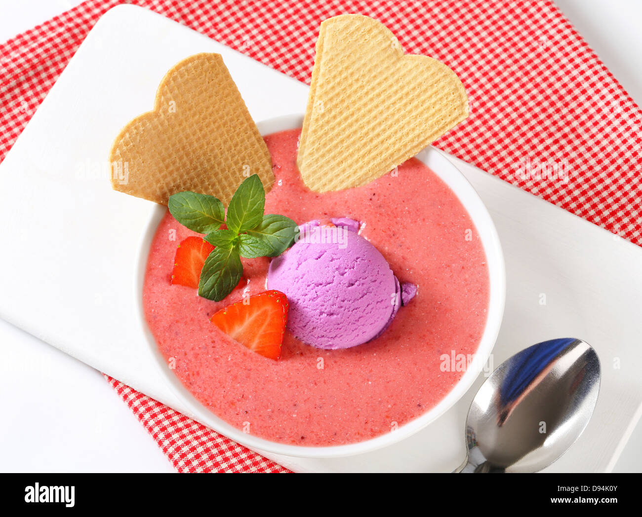 Chilled strawberry soup with scoop of ice cream and wafers Stock Photo