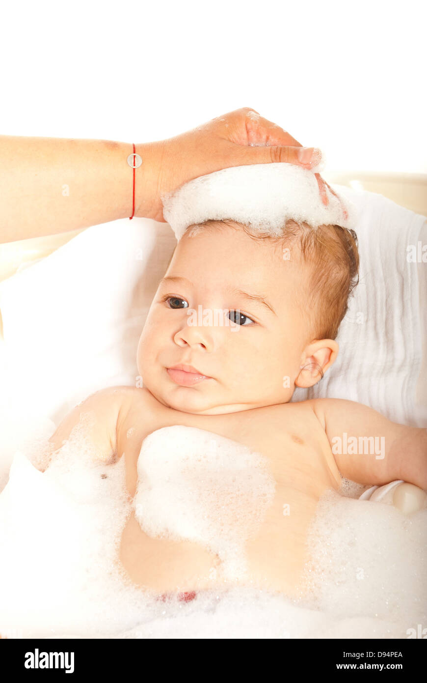Mother washing her baby boy in a bathtub with foam Stock Photo Alamy