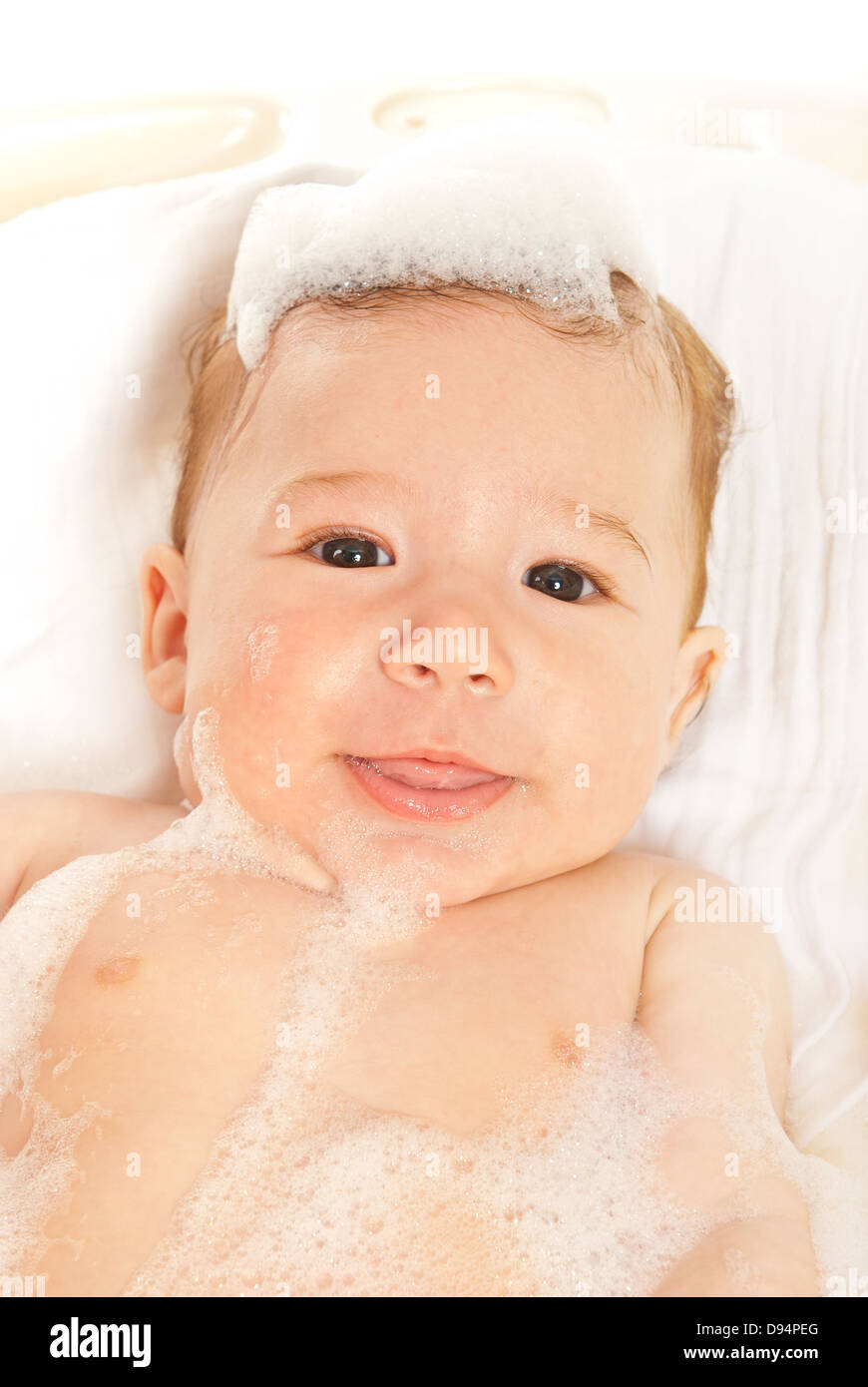 Smiling baby boy in bath with foam on his face Stock Photo Alamy