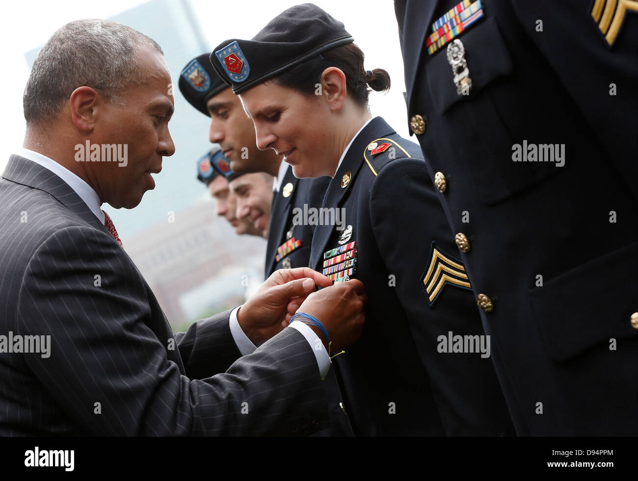 Massachusetts Governor Deval Patrick pins a medal on military service member Stock Photo