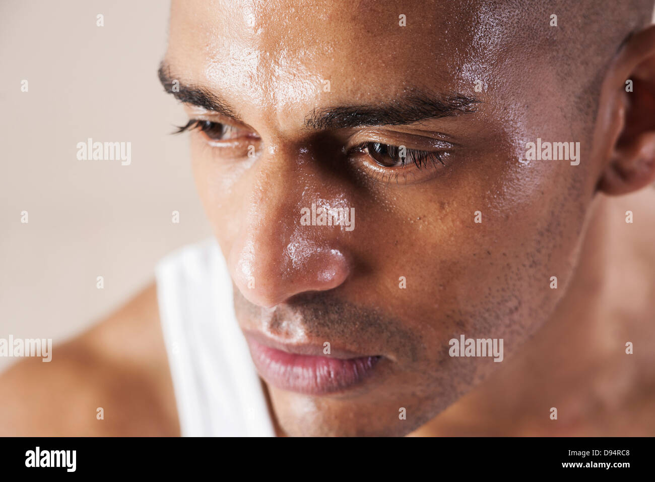 CloseUp Man's Sweating Face in Studio with White Background Stock