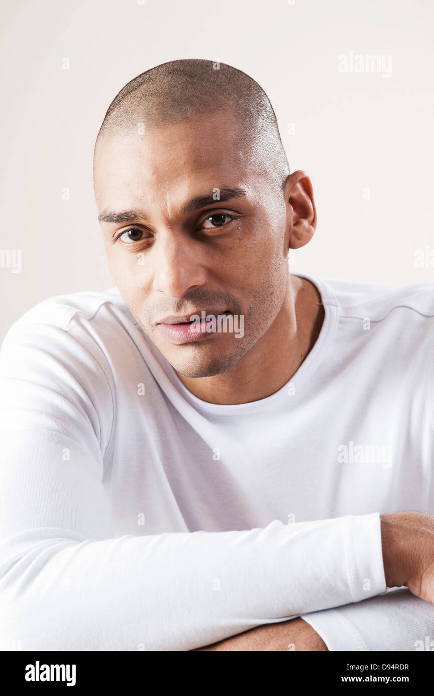Portrait of Man Looking at Camera in Studio with White Background Stock Photo