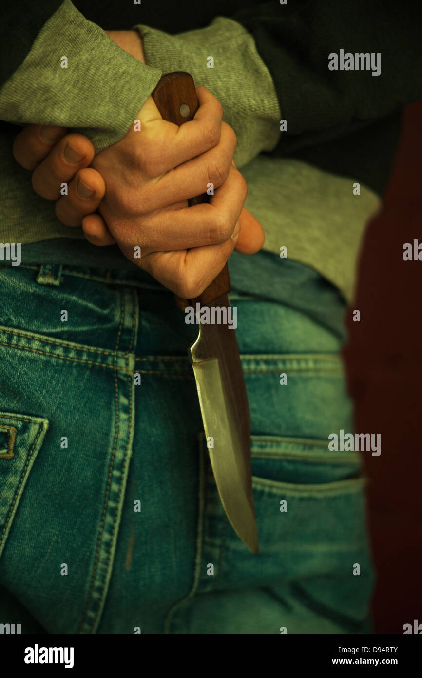 Closeup of Young Man holding Knife Behind Back Stock Photo Alamy
