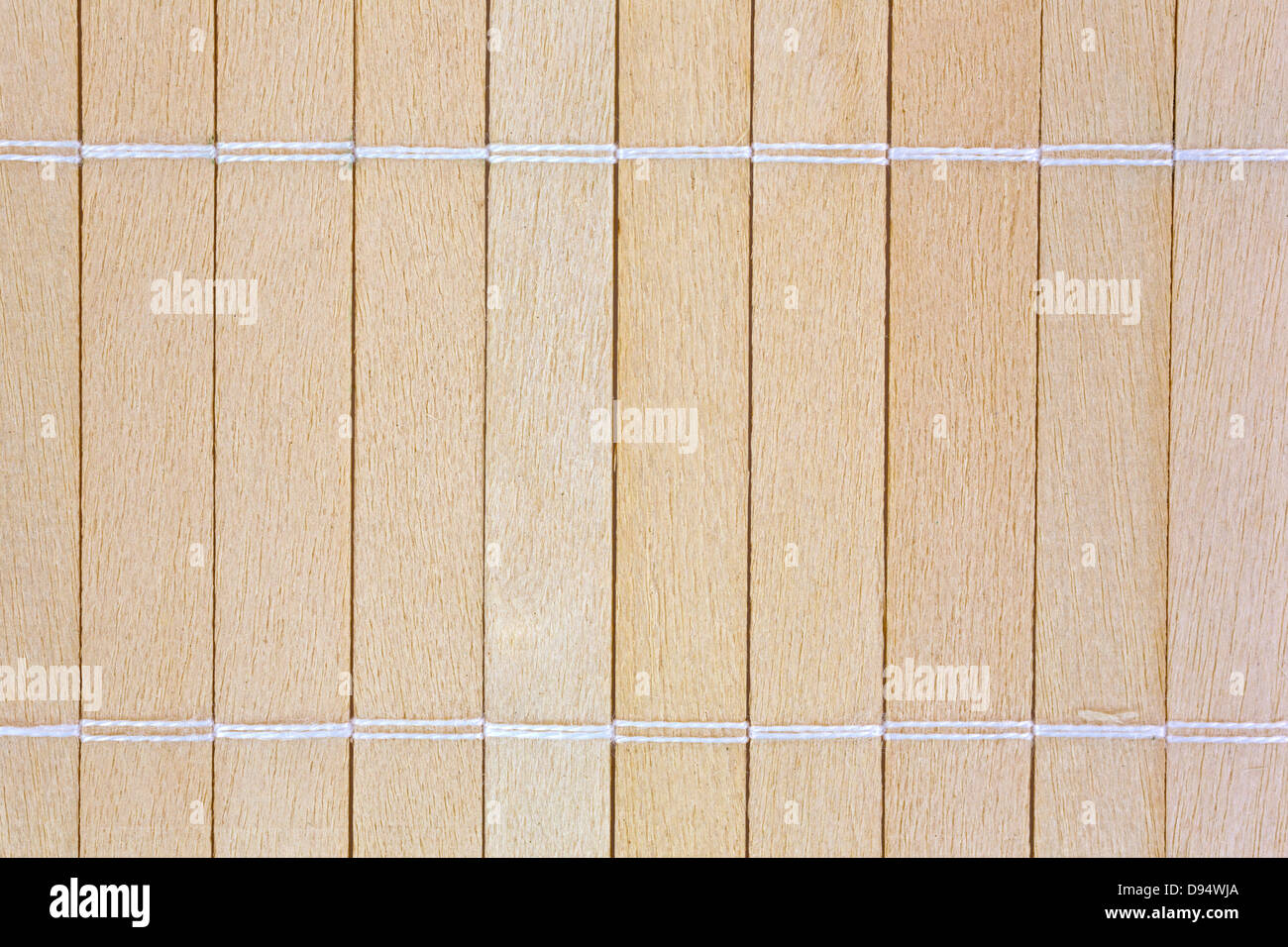 A very close view of small wood slats that have been joined together with string. Stock Photo