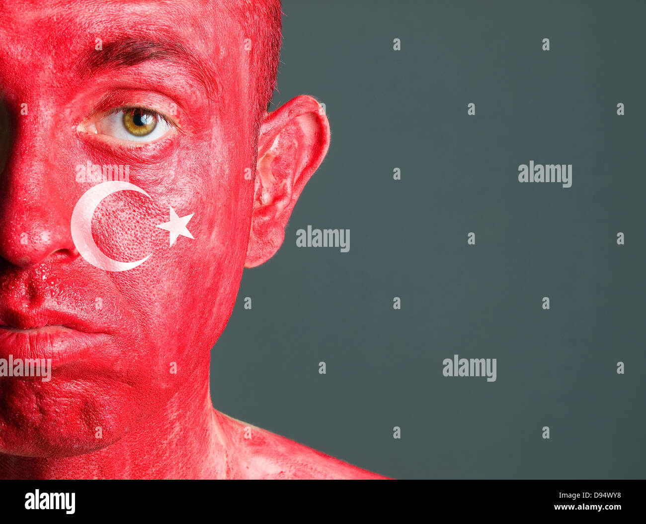 Face man turkish flag, isolated on dark background and looking at camera with sad expression. Stock Photo