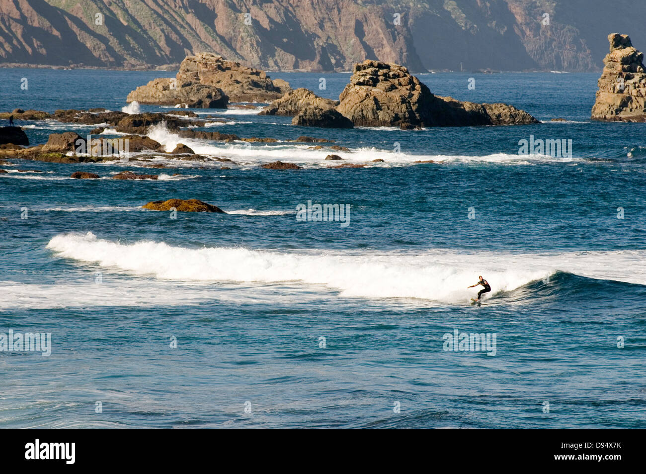 surfing surf surfers surfer tenerife wave waves riding rocks canary islands canaries Stock Photo