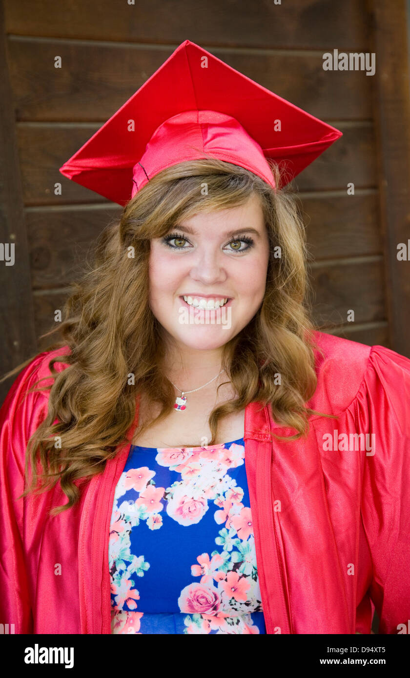 A senior in high school in her graduating cap and gown Stock Photo