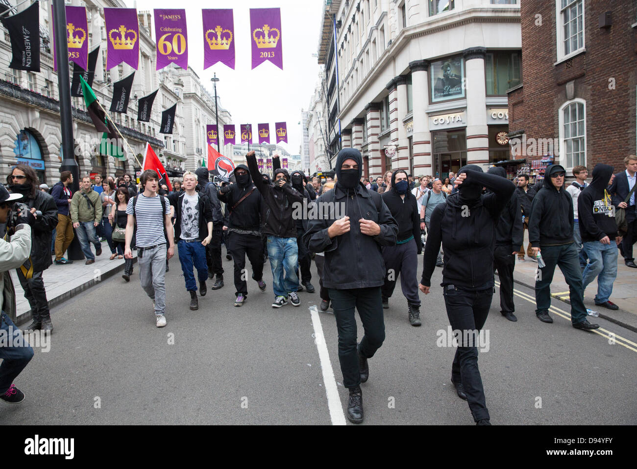 London, UK. 11th June 2013. Anti G8 protesters dressed in black are marching while holding banners and flags. Credit:  Lydia Pagoni/Alamy Live News Stock Photo