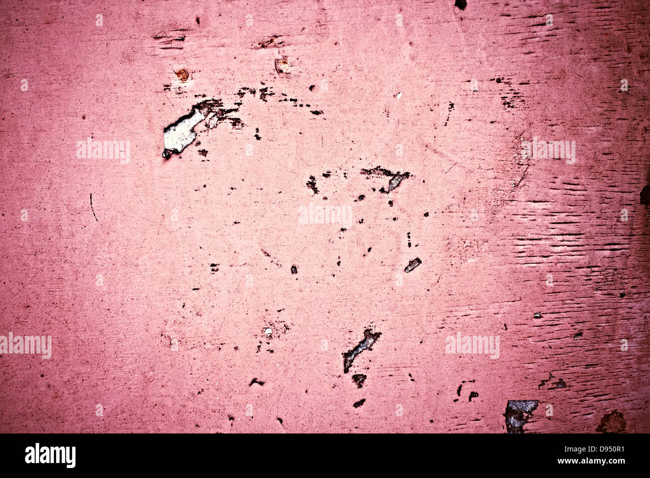 The old concrete pink wall with pink scraps of paper ads Stock Photo