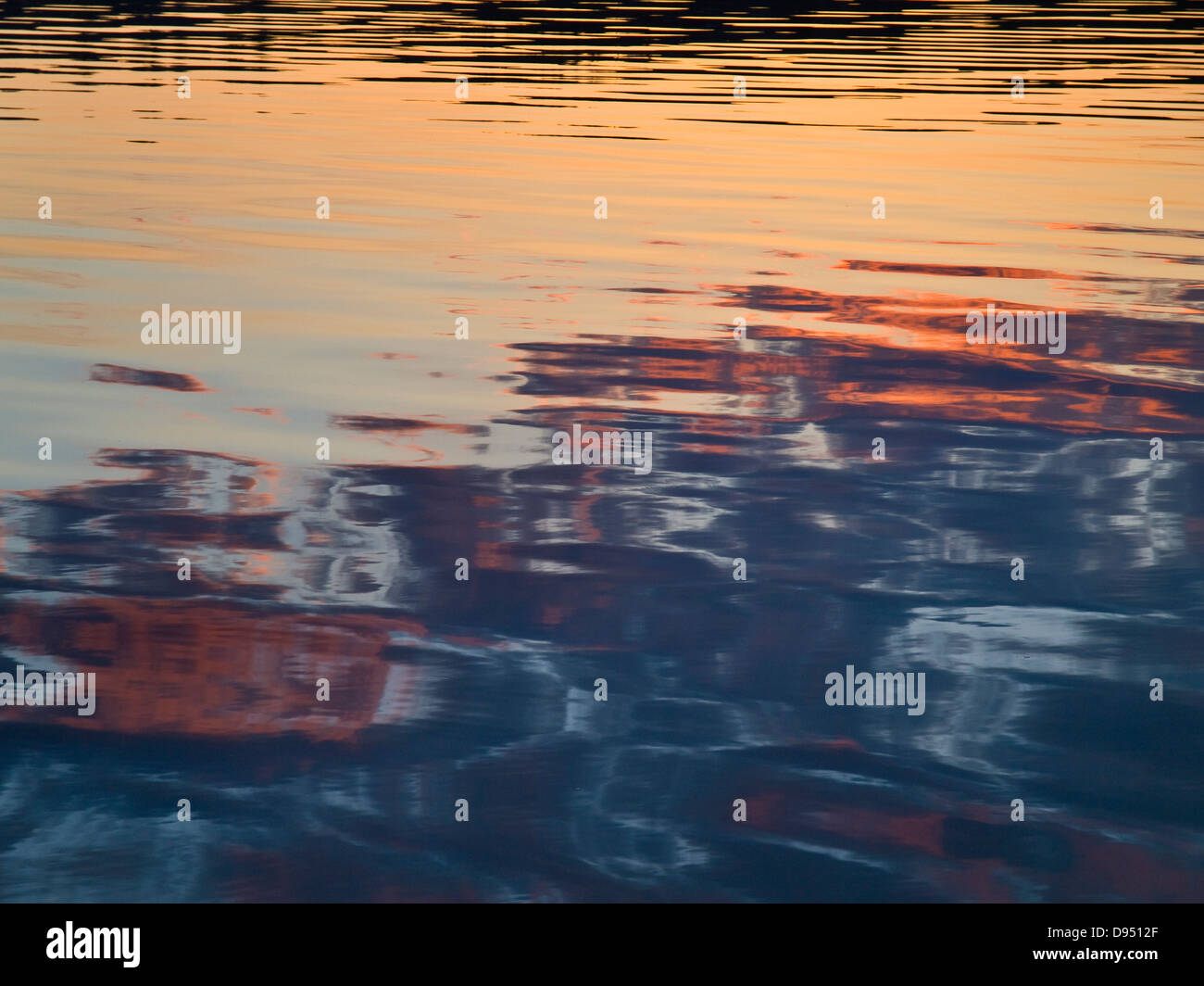 Golden evening light reflects in ripples of the sea Stock Photo - Alamy