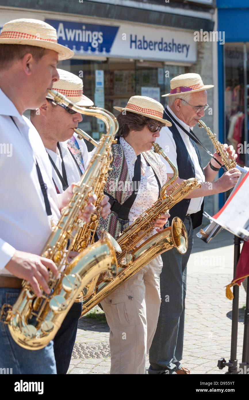 three male one female in pork pie hats playing tenor and baritone saxaphones and brass clarinet Stock Photo