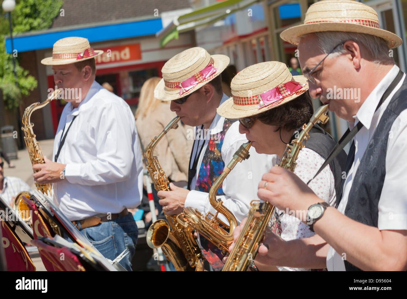 three male one female in pork pie hats playing tenor and baritone saxaphones and brass clarinet Stock Photo