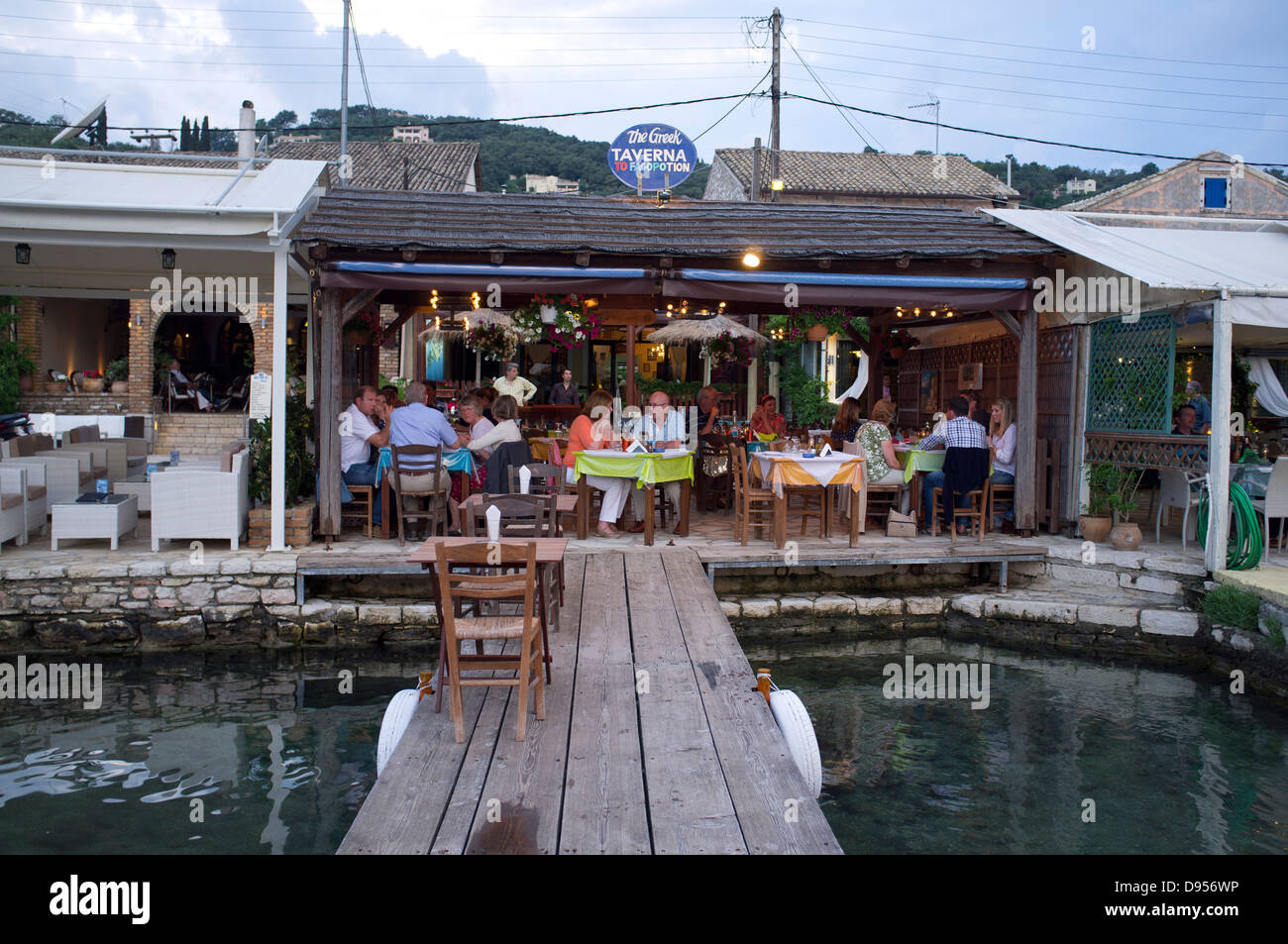 A waterfront taverna in the town of Agios Stefanos on the Northeast coast of the island of Corfu, Greece Stock Photo