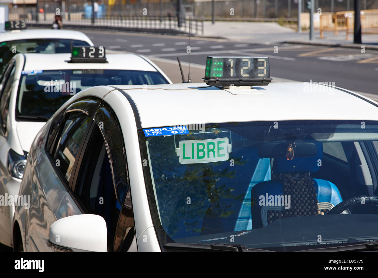 row of hybrid vehicle taxi cabs on a rank in valencia spain Stock Photo