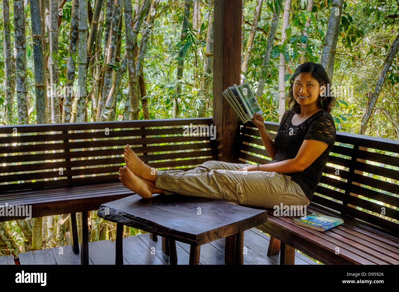 A guest enjoys a TREE HOUSE deck at OUR JUNGLE HOUSE a lodge in the  rainforest near KHAO SOK NATIONAL PARK - SURATHANI PROVENCE Stock Photo -  Alamy