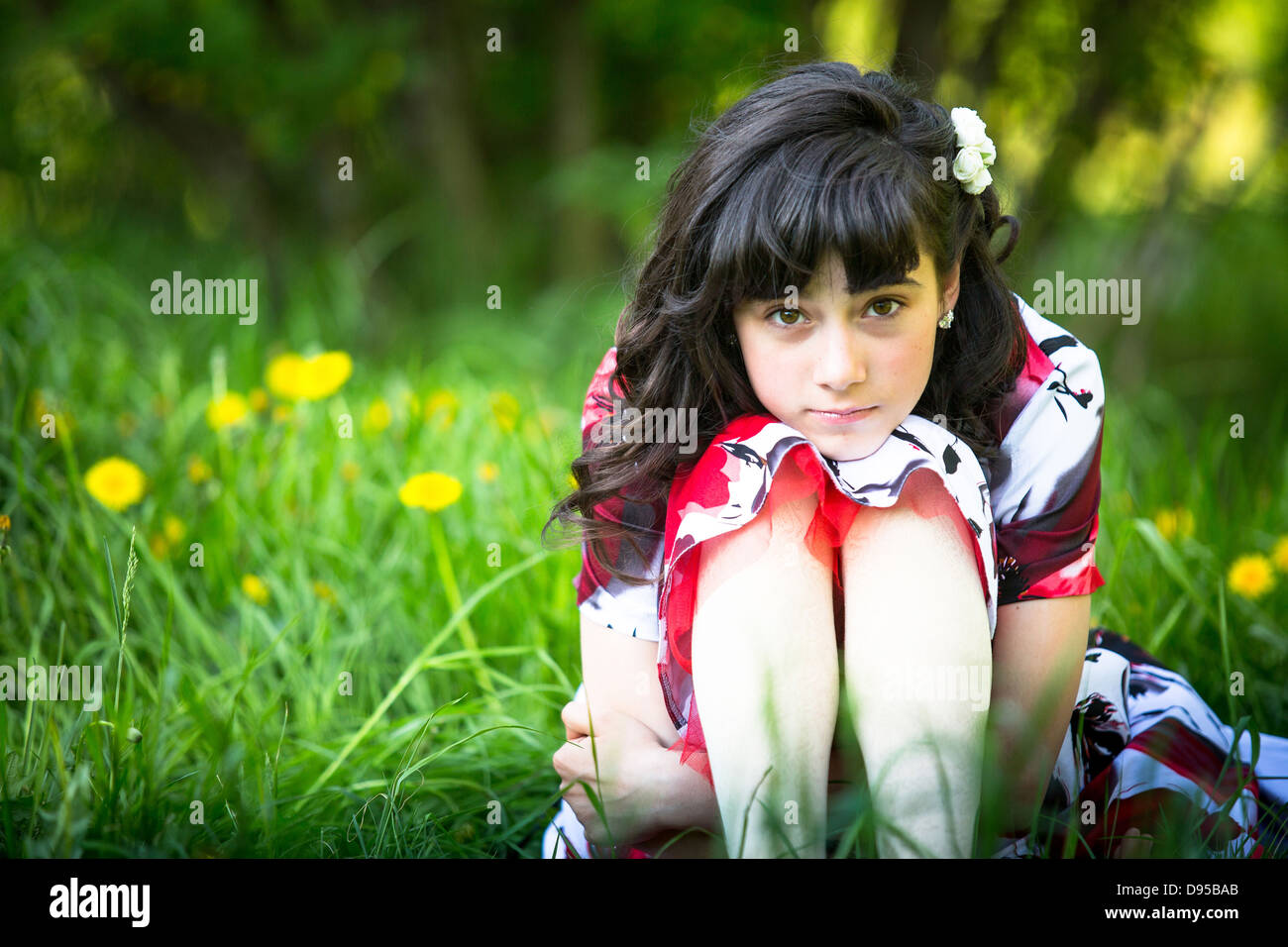 Portrait of a teen girl sitting in the grass Stock Photo