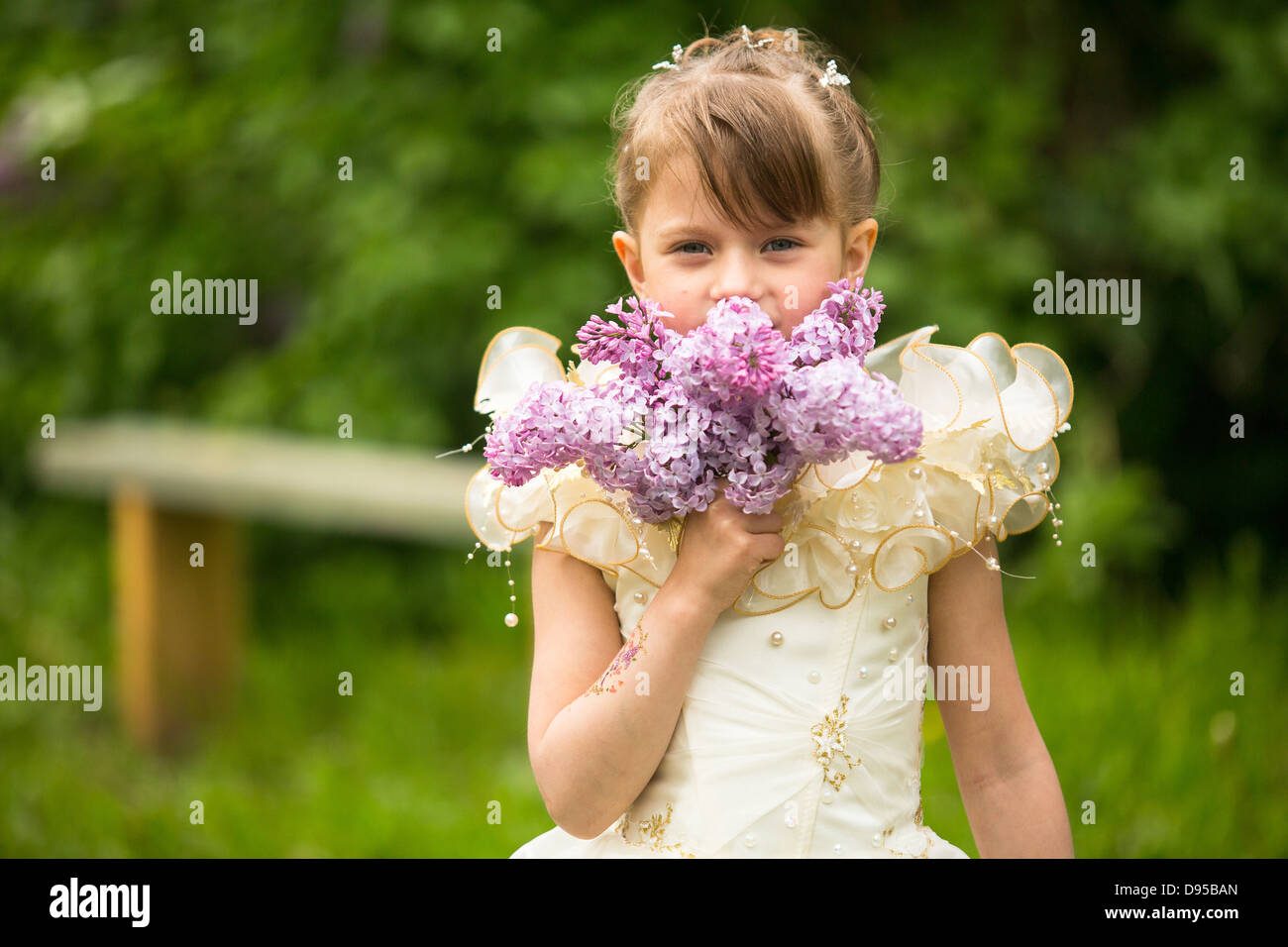 Portrait of a little girl with a bouquet of lilacs outdoors Stock Photo ...