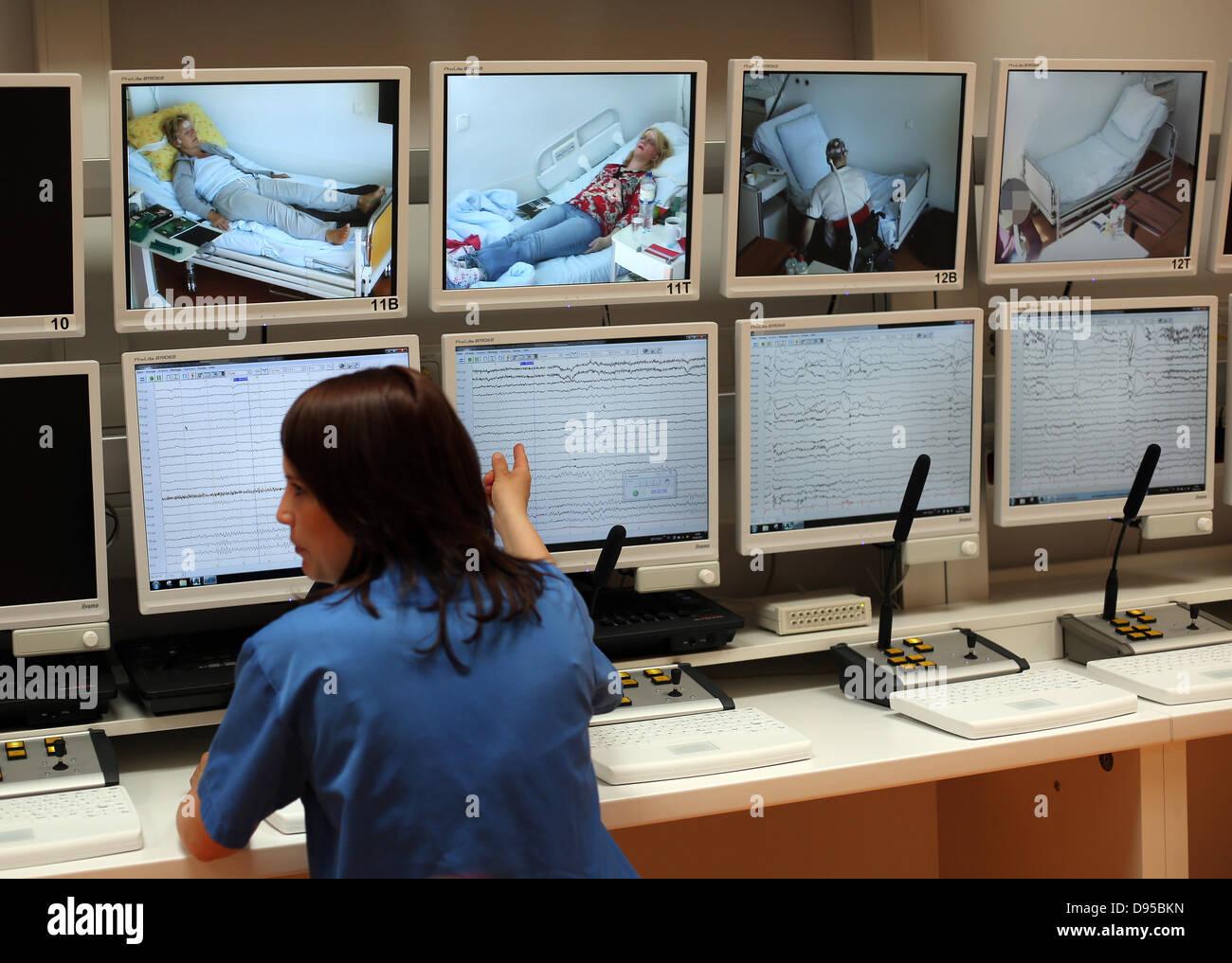 Two nurses watch patients on monitors in the new epilepsy monitoring
