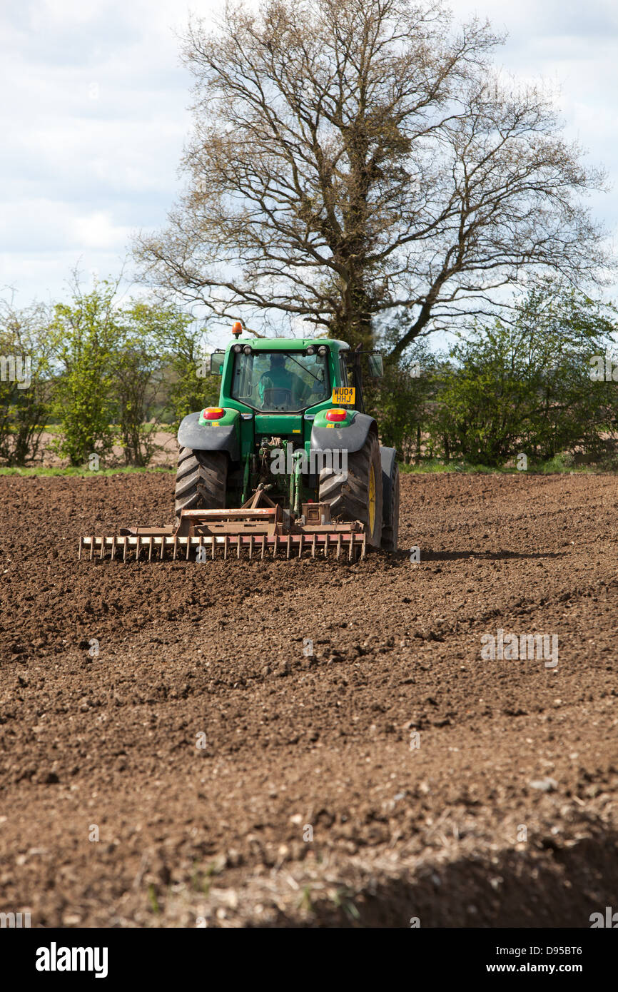 A tractor breaks up and aerates the soil in a field Stock Photo - Alamy