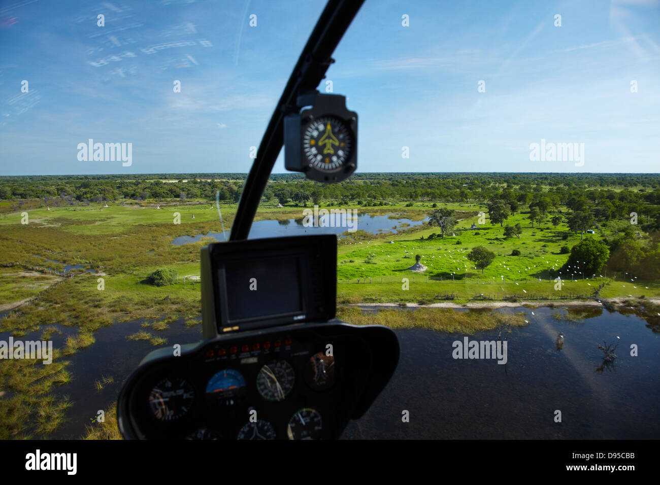 Robinson R44 helicopter over Okavango Delta, Botswana, Africa- aerial Stock Photo