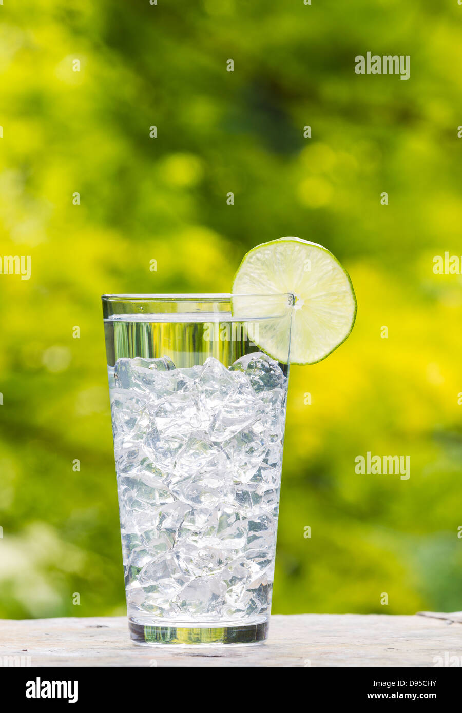 clear fresh water in glass with large ice cubes outdoors Stock Photo ...