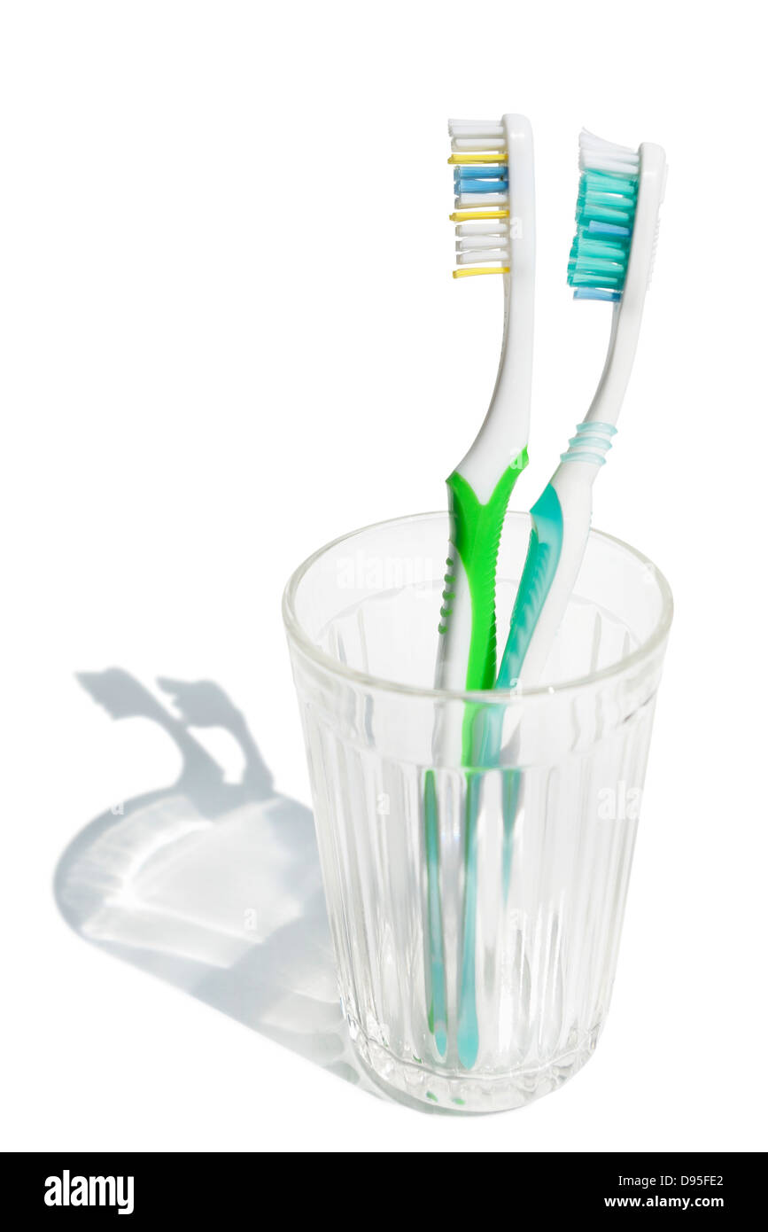 Toothbrushes in transparent glass Stock Photo