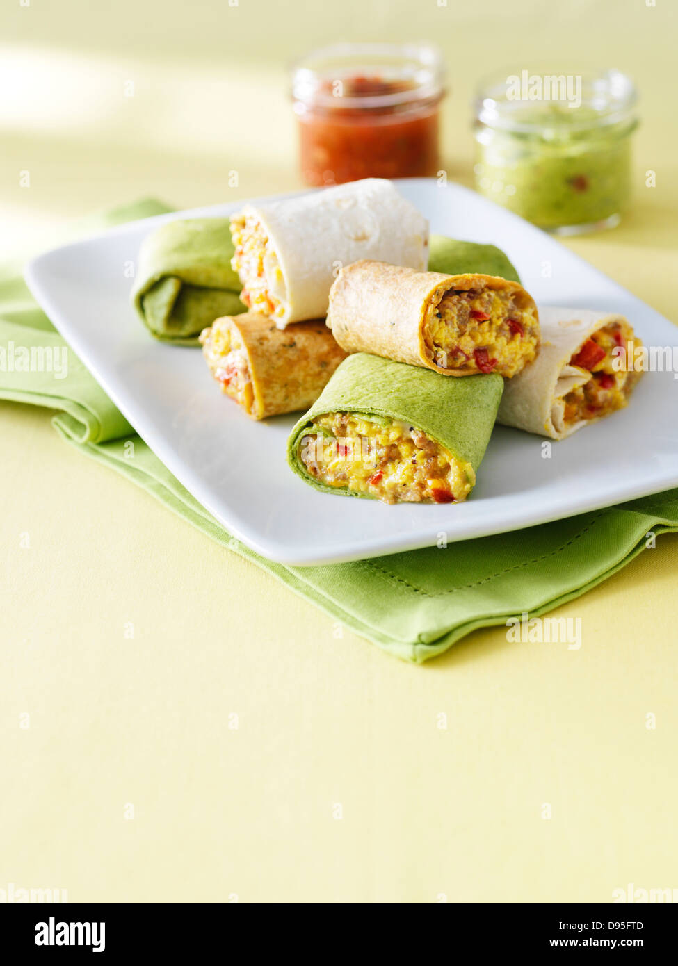 egg, meat and red pepper burrito breakfast wraps cut and stacked on a